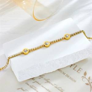 Elegant gold titanium steel bracelet with roman numeral charms and sparkling zircons