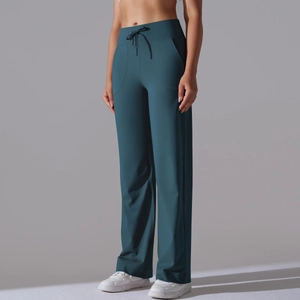 Detail view of high-waist drawstring design and side pockets on dark teal yoga pants