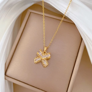 Macro shot of gold butterfly pendant with cubic zirconia on a luxury silk background