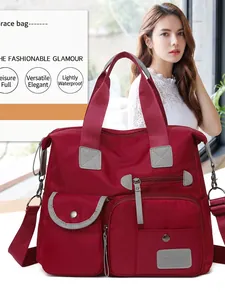 Large burgundy oxford cloth tote bag with multi-pocket design and grey shoulder straps