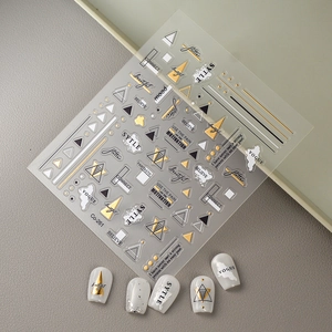 Gold bronzing nail stickers with minimalist geometric lines and VOGUE style typography