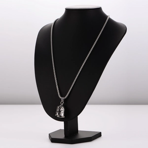 Retro silver puppy bell pendant necklace displayed on a black bust mannequin