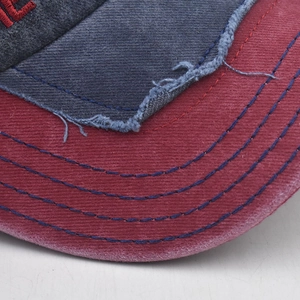 Close-up of vintage distressed baseball cap with contrast stitching and frayed edge detail