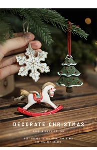 Detail of resin Christmas ornaments featuring snowflake and tree with relief textures