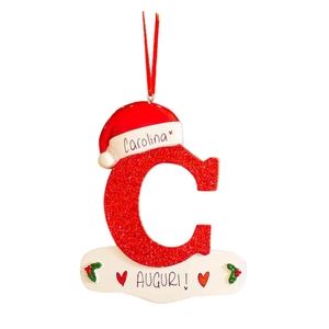 Red acrylic letter C ornament with glitter, Santa hat and holiday banner on white background