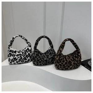 Three leopard print plush hobo bags in grey and brown faux fur on a white pedestal