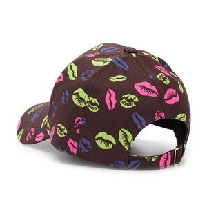 Detail of dark brown baseball cap with colorful lip prints and metal buckle closure