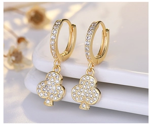 Close-up of gold-plated silver clover earrings with sparkling cubic zirconia pavé
