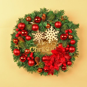 Christmas wreath with red baubles, golden snowflakes, pine cones and Merry Christmas sign