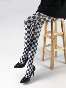 Detail showing high-stretch black and white checkerboard patterned tights for women