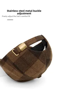 Detail of vintage brown plaid cap featuring an adjustable stainless steel metal buckle