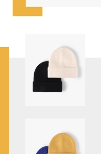 Flat lay detail of ribbed knit beanies in black, cream, ginger, and navy blue