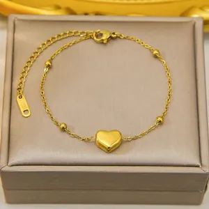 Golden stainless steel heart pendant necklace with delicate beaded chain and lobster clasp