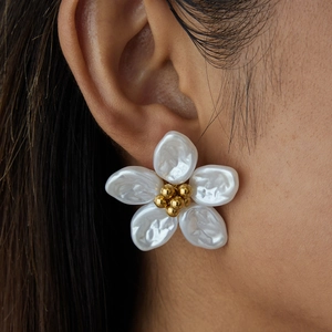 Romantic 18K gold-plated stainless steel flower earrings with opal white petals on model