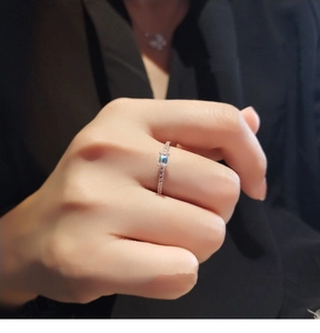 Detail of rose gold sugar cube ring with rectangular gemstone and pavé diamonds
