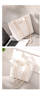 Close-up of white quilted tote bag featuring rope handles and gold logo detail