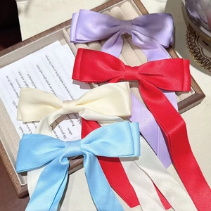 Detailed set of four silk-texture bow hair clips in purple, red, beige, and sky blue colors