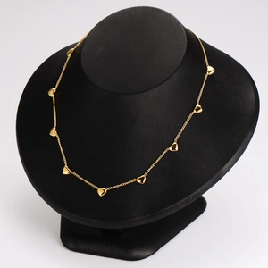 Elegant gold stainless steel heart pendant necklace displayed on a black model bust