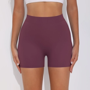 Macro detail of plum purple high waist yoga shorts featuring peach lift textured fabric