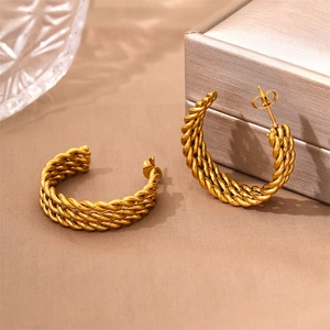 Vintage 18k gold plated stainless steel twisted rope C-hoop earrings on a soft texture