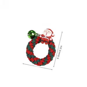 Detailed view of Christmas scrunchie with Santa doll and green bell decoration