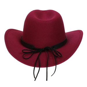 Detailed macro of burgundy felt cowboy hat with a black leather decorative bow band