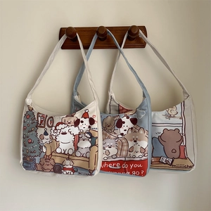 Detailed view of three canvas tote bags with cute cartoon bear and dog illustrations