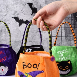 Close-up of plush Halloween trick-or-treat bags with festive pumpkin and bat designs