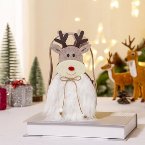 Felt Christmas gift bag with reindeer design and plush trim on a festive background