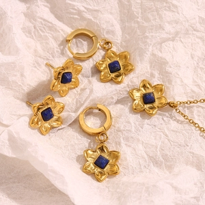 Detailed view of 18K gold-plated flower jewelry set with square blue gemstones