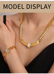 Close-up of gold chunky chain necklace with shell pendant on a model neck
