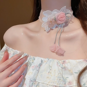 Detail of pink fabric rose choker with delicate lace leaves and tassel drawstrings