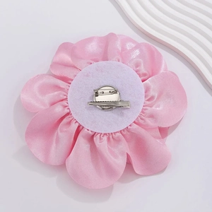 Detailed back view of pink satin rose brooch with dual clip and pin fastener