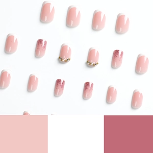 French tip press-on nails in soft pink with white edges and sparkling glitter accents