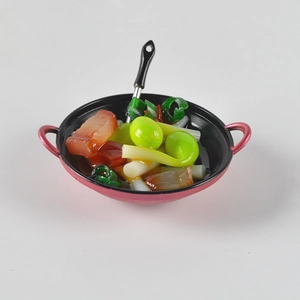 Detailed macro view of a miniature red wok with realistic stir-fry food for dollhouses