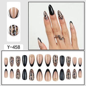 Leopard print press-on nails with black French tips and gold metallic line accents