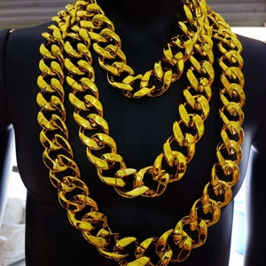 Detailed close-up of multiple golden Cuban link chains in various lengths on a black bust