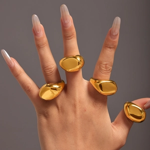 Irregular wide gold-plated stainless steel rings shown as a set on fingers with 18K finish