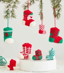 Detail of knitted Christmas stocking ornaments with festive reindeer and Santa patterns