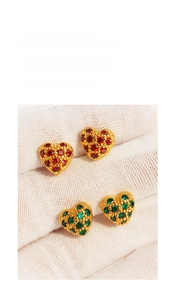 Detail of brass heart studs with red and green cubic zirconia in pavé setting