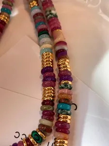 Macro view of 18k gold plated spacer beads and colorful natural stone bead necklace