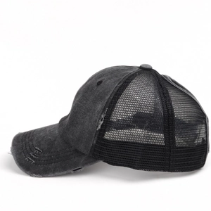Close-up of distressed brim details on a washed cotton ponytail mesh baseball cap