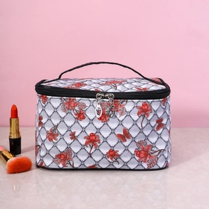 Floral print cosmetic bag with grey lattice pattern and dual zippers on marble surface