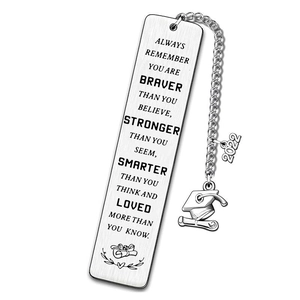 Macro detail of stainless steel bookmark with inspirational text and graduation charms