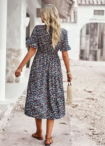 Detail of navy floral midi dress featuring ruffled short sleeves and elastic waist design