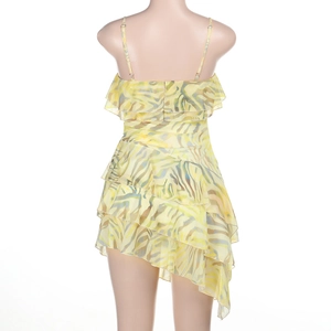 Detail view of the yellow zebra print layers and irregular ruffle hem on a chiffon dress
