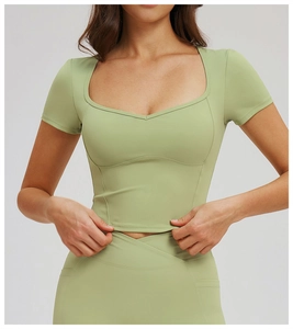 Detail of avocado green square neck yoga top with heart-shaped stitching and matte finish