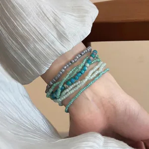 Bohemian multilayer beaded bracelet set with cold-tone resin beads on a textured sleeve
