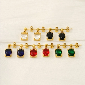 Macro view of five pairs of colorful oval cubic zirconia stud earrings in gold settings