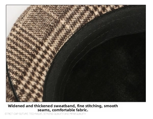 Detail of widened sweatband and precision stitching on a brown plaid flat cap